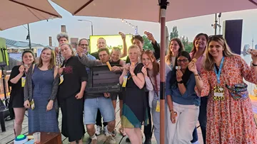 Group of people holding awards at a celebration.