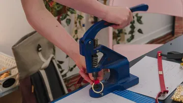 A press is used to secure a key ring.