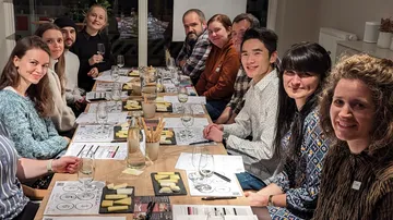 A group of people is sitting at a set table.