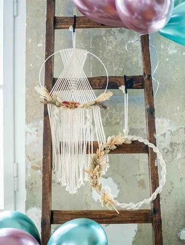 Wall shelf with decorative hanging objects and colorful balloons.