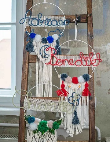 Decorative wall hangers with colorful fabrics on a ladder.