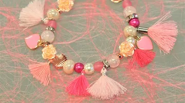 Colorful bracelets with tassels and hearts on a table