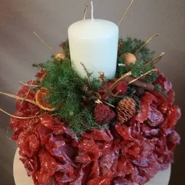 Candle stands in a decorative arrangement of plants and DETAILS.