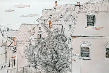 Roofs and trees surround an urban residential area.