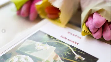 Colourful bouquets of flowers lie next to a workshop flyer.