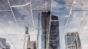 Reflective buildings reflect the sky and the surrounding area.