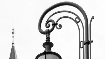 Curved lantern in front of a building tower