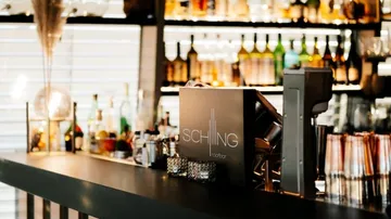 Bar with drinks ready to be served in a modern setting.