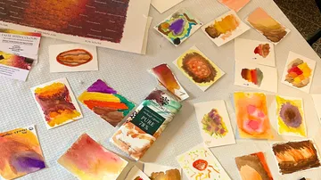 Art cards are scattered while colors and materials are presented.