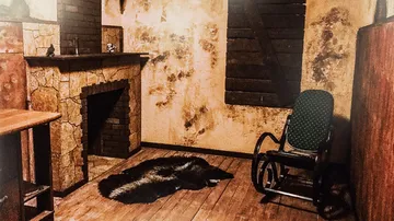 A rocking chair is placed next to a fireplace in a room.