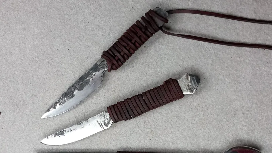 Two knives are lying on a grey surface, visible.