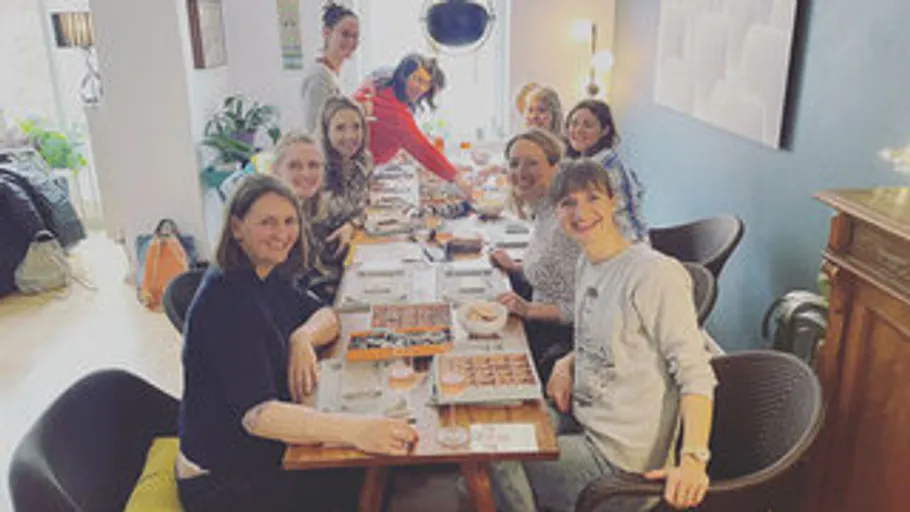 Group of women sitting at a dining table indoors.