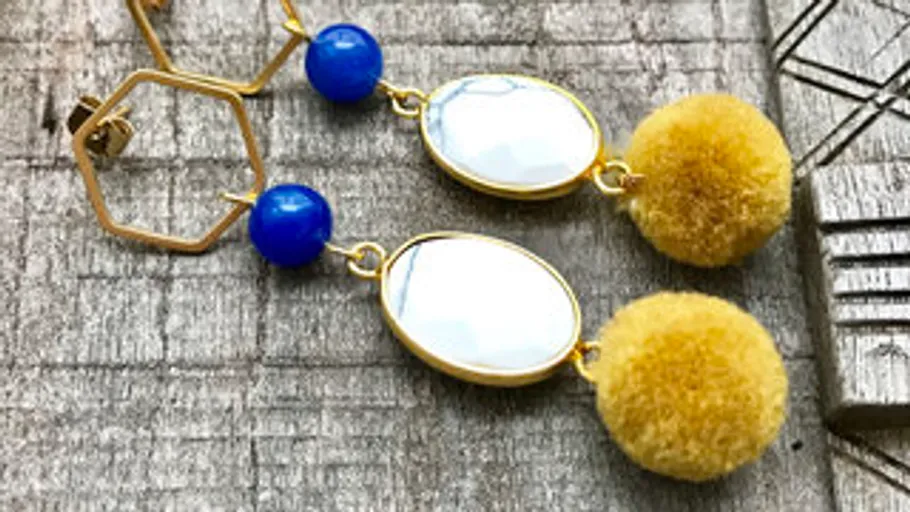 Hanging earrings with golden accents and colorful elements.