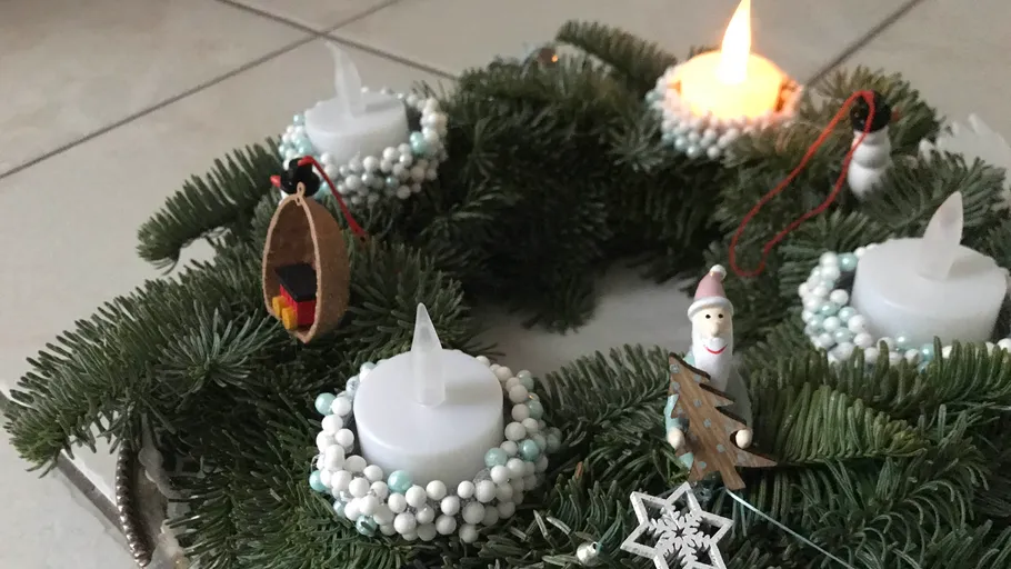 Advent wreath with burning candles and festive decoration