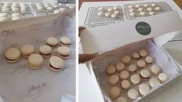 Macarons are carefully arranged in a box, ready to serve.