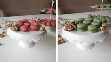 Colourful macarons on a white cake stand decorated with flowers