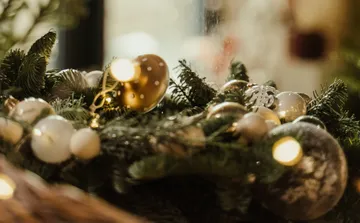 Christmas decoration is on pine branches in the background.