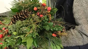 Ein größerer Blumenstrauß wird von einer Person gehalten.