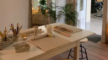 A table with materials for creative work stands in a room.