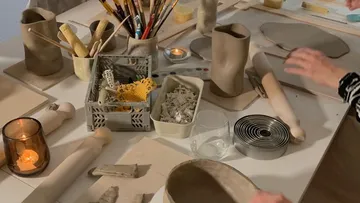Pottery materials are worked on a work table.
