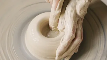 Hands form a sound circle on the turntable.