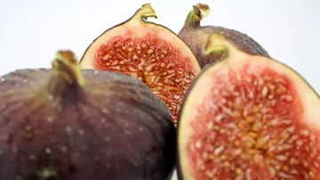 Figs, cut in half, show pink-fruity flesh core.