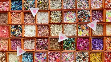 Colourful beads in boxes, organized and ready for craft activities
