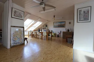 Bright room with furniture and artwork, clean and cozy.