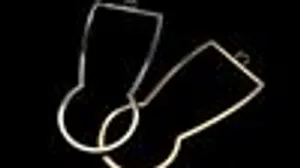 Two glasses stand side by side on a black background.