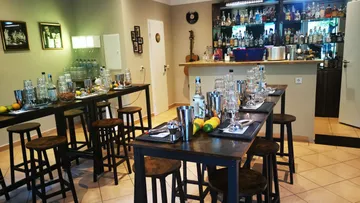 Tables with glasses and fruit in a bar setting.