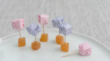 Colourful sticks with appetizers on a white plate