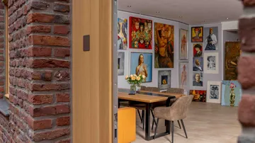 Artfully furnished room with table and chairs.