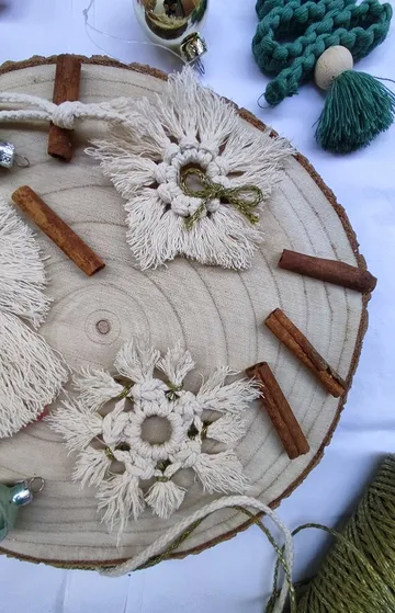 Macrame objects on a wooden board with cinnamon sticks