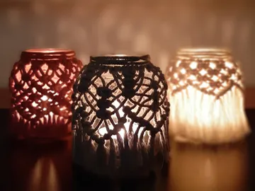 Three decorative tea lights emit warm light.