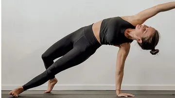 Woman doing a lateral support exercise on a yoga mat.
