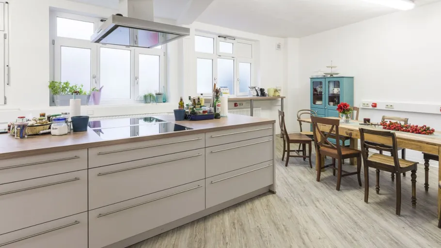 Modern kitchen with island and dining table.