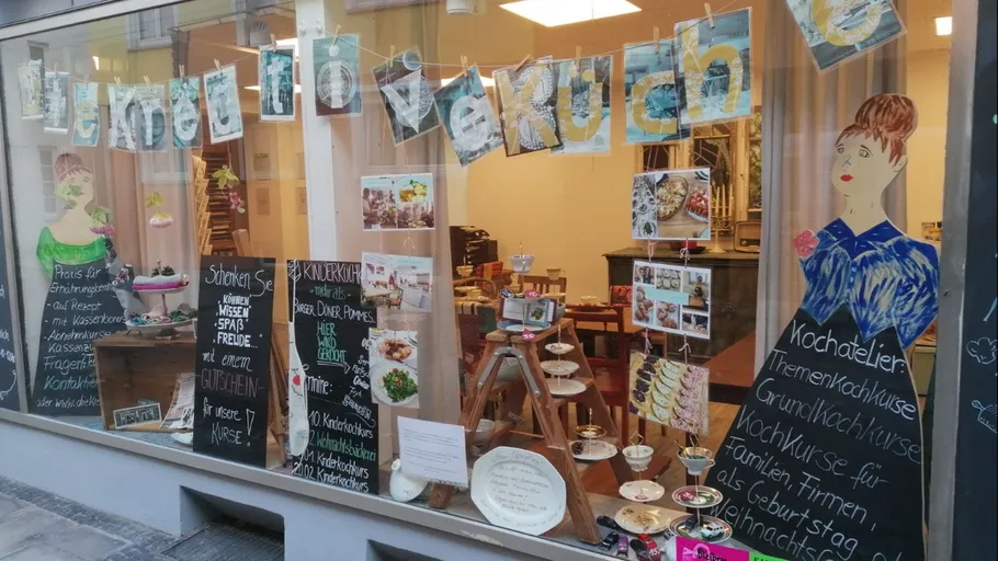 Storefront with cooking class advertisements.