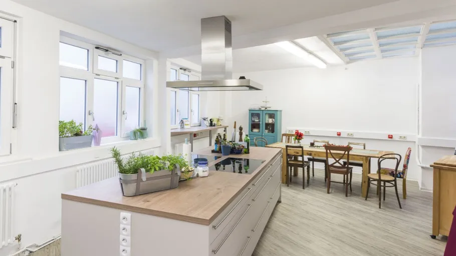 Modern kitchen with island and dining table.