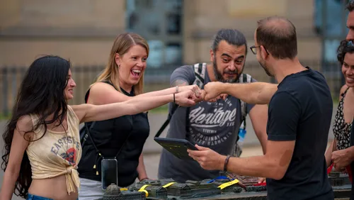Group of people are smiling and shaking fists.