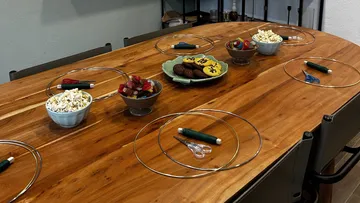 Table prepared for a celebration with snacks and utensils.