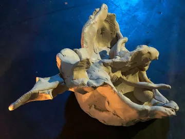 Sculpture with abstract figures moving back and forth.