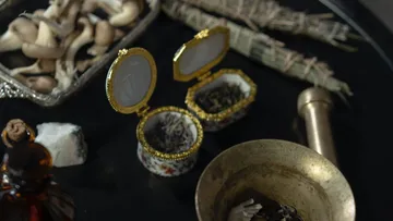 Smaller objects lie on a dark table.