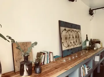 Wooden table with decorations and plants in a room.