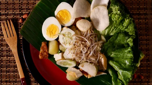 A plate with various fields of vegetables and eggs.