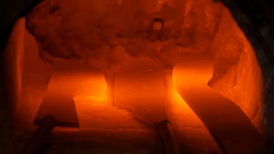 Glowing metal in an oven surrounded by heat.