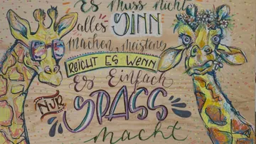 Two giraffes with glasses and flower wreath, colorful lettering. Text: `Not everything has to make sense, it's usually enough if it's just fun. `
