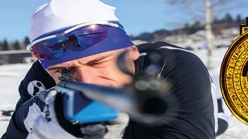 Sportsman aims at snowfields with a rifle.