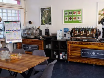 Coffee vending machines prepare drinks in a modern café environment.