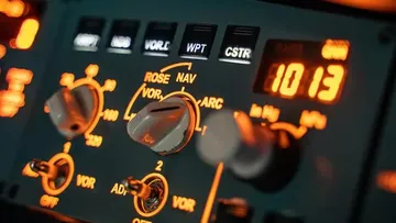 Control elements light up, buttons are adjusted, cockpit environment visible.