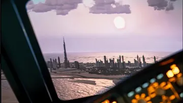 Cockpit view of city landscape at sunset.
